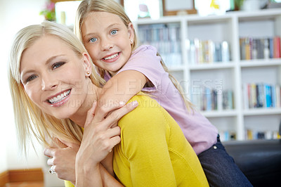 Buy stock photo Portait of a young mother and her daughter at home