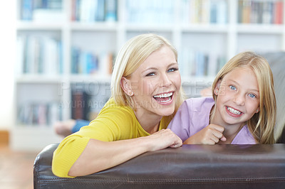 Buy stock photo Laughing, mother and daughter on sofa in home portrait  with happiness on holiday or vacation. Kid, relax and smile with mom on couch in house, apartment or funny chat in living room together