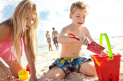 Buy stock photo Children, sand and toys at beach for vacation, adventure and travel for family holiday in summer. Boy, girl and bucket in nature with smile, energy and development in Bali for sunshine by ocean