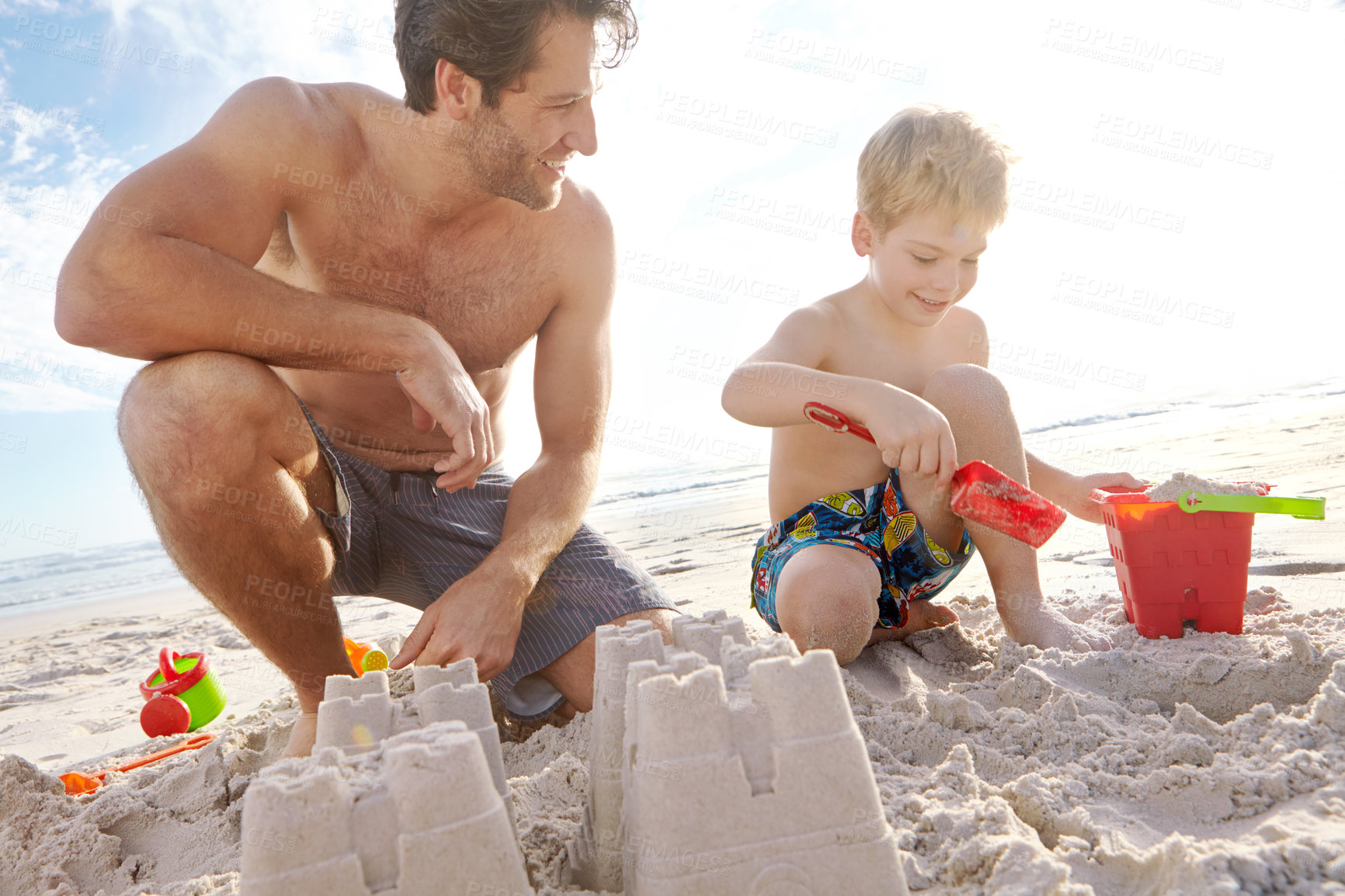 Buy stock photo Father, son or building with sand castle and smile on beach for vacation, sunshine in nature. Male person, boy child or holiday with bucket by sea for learning and development, travel in Mauritius