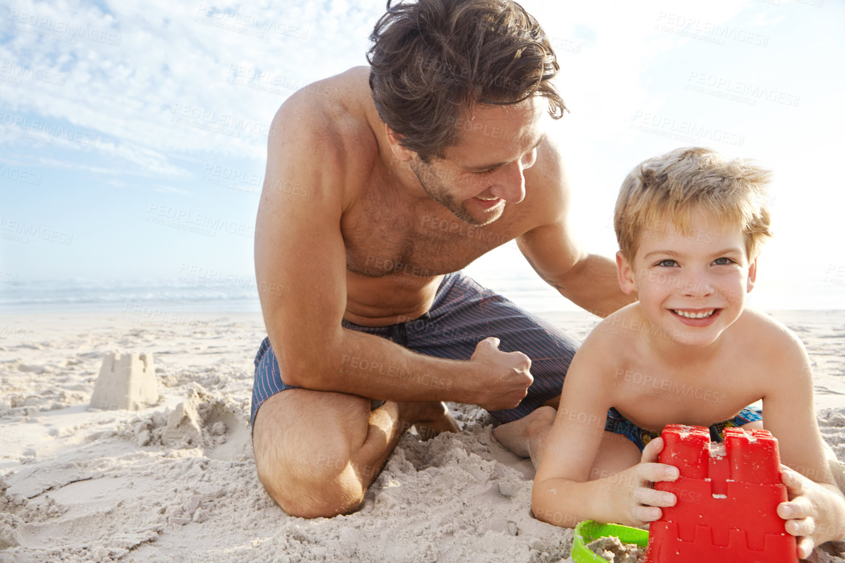 Buy stock photo Father, smile or son in portrait with bucket for sand castle on beach, vacation in nature. Male person, boy or holiday with plastic container by ocean for learning or development, travel in Mauritius