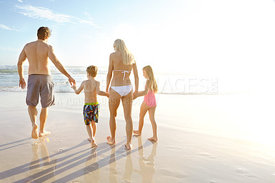 Buy stock photo Rearview shot of a family walking on a beach
