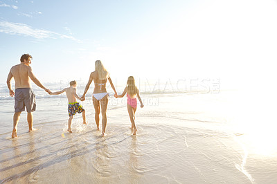 Buy stock photo Freedom, walking and family holding hands at a beach for summer, fun and bonding at sunset together. Travel, people or back of children with parents at sea for vacation, holiday or tropical adventure