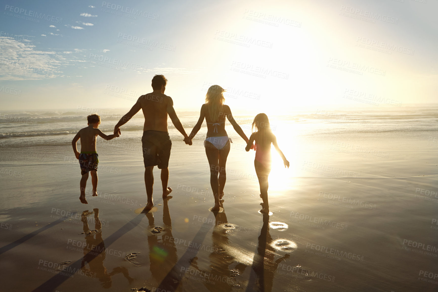 Buy stock photo Family, beach and holding hands in sunset for holiday, vacation and summer together. Back of parents, people and children in swimwear by ocean and sunshine for support, love and security or travel