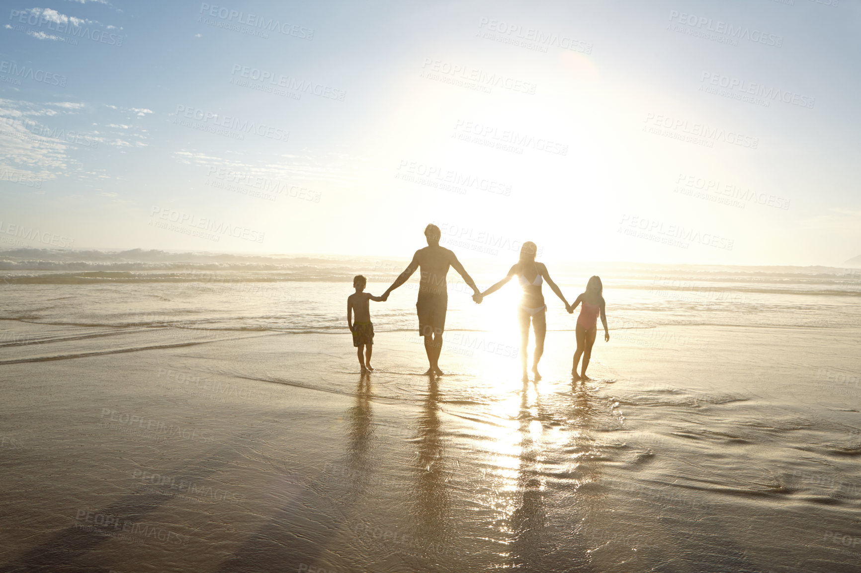 Buy stock photo Family, holding hands and silhouette on beach in outdoors at sunset for vacation, holiday or getaway. People, support and community by ocean on sand with love, care and children with parents by waves