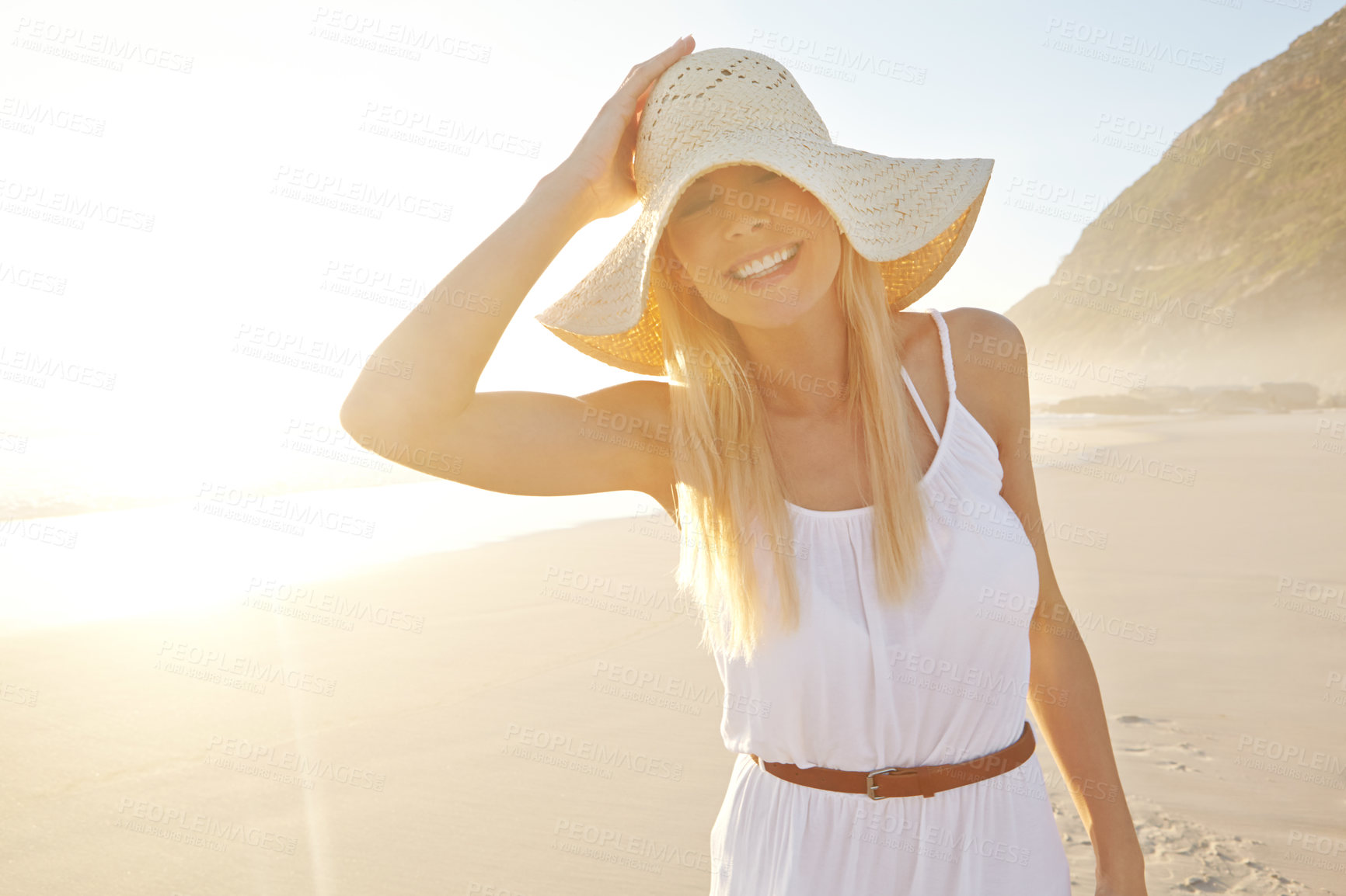 Buy stock photo Beach, woman and happy for walking, travel and adventure or vacation in nature with hat. Female person, journey and smile with pride for holiday, summer and sunshine on tropical island in Bali 