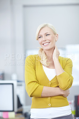 Buy stock photo Shot of an attractive young woman standing in an office