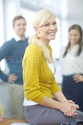 Buy stock photo Portrait of an attractive young woman standing in an office with coworkers in the background