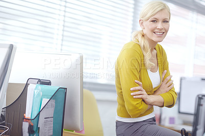 Buy stock photo Portrait of a happy businesswoman sitting on her desk with her arms crossed while looking at camera. Confident female entrepreneur by her desktop. Happy professional ready for success in her startup