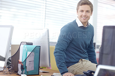 Buy stock photo Portrait of a handsome young businessman sitting in his office