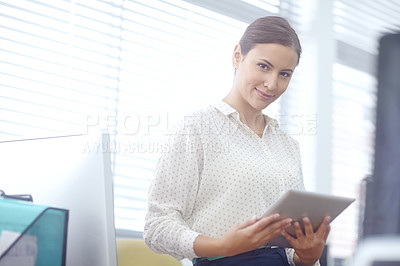 Buy stock photo Portrait of an attractive young businesswoman using a digital tablet during work
