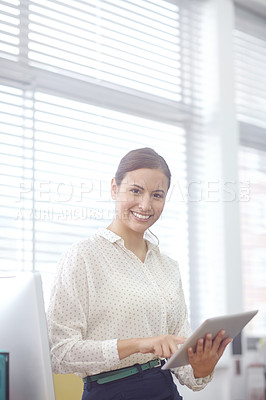 Buy stock photo Portrait of an attractive young businesswoman using a digital tablet during work