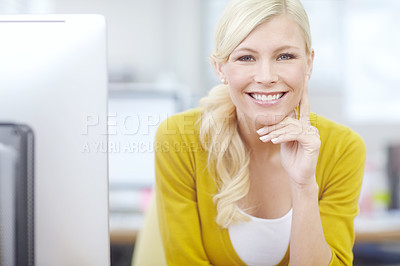 Buy stock photo Portrait of a businesswoman sitting behind her computer at her desk and smiling while looking at the camera. One confident creative designer sitting in an office. Happy entrepreneur at her workplace