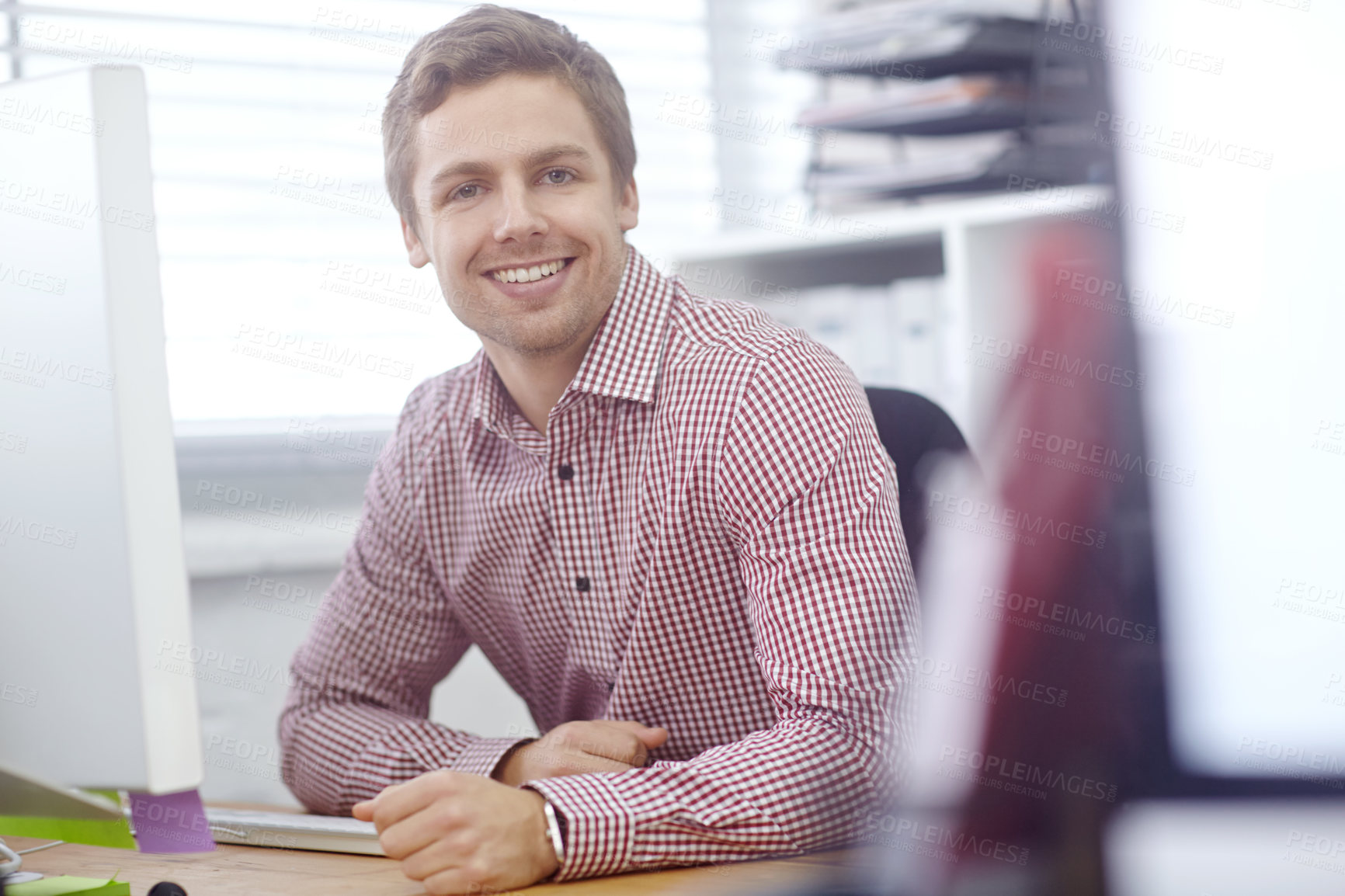 Buy stock photo Portrait of a handsome young businessman sitting in his office