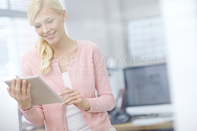 Buy stock photo Cropped shot of an attractive young businesswoman using a digital tablet