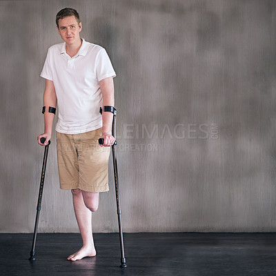 Buy stock photo Portrait, crutches and man with disability in healthcare centre for walking, muscle strength and medical for support. Amputee, exercise and physiotherapy for physical therapy with rehabilitation