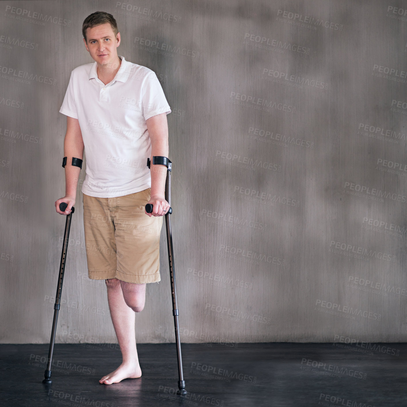 Buy stock photo Portrait, crutches and man with disability in healthcare centre for walking, muscle strength and medical for support. Amputee, exercise and physiotherapy for physical therapy with rehabilitation