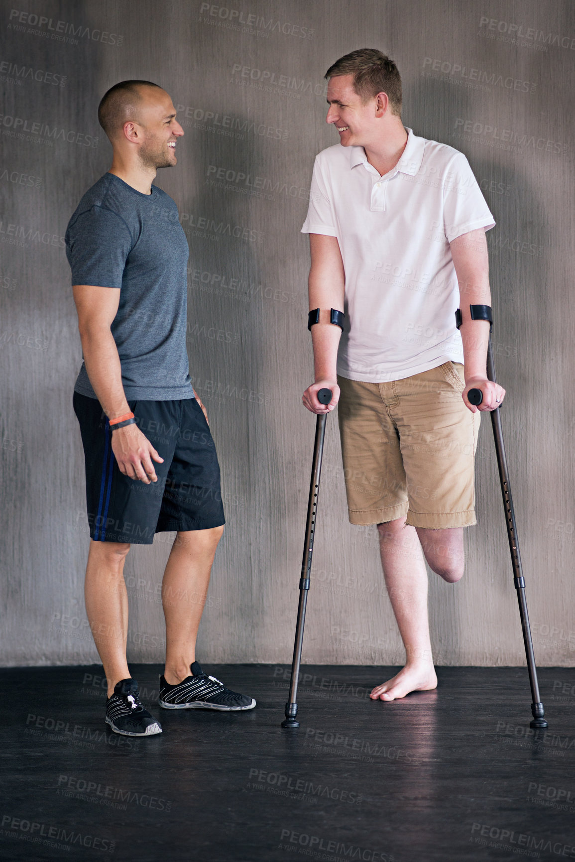 Buy stock photo Physiotherapy, crutches and man with disability in healthcare center for walking, muscle strength and coach for support. Amputee, exercise and physiotherapist for physical therapy with rehabilitation