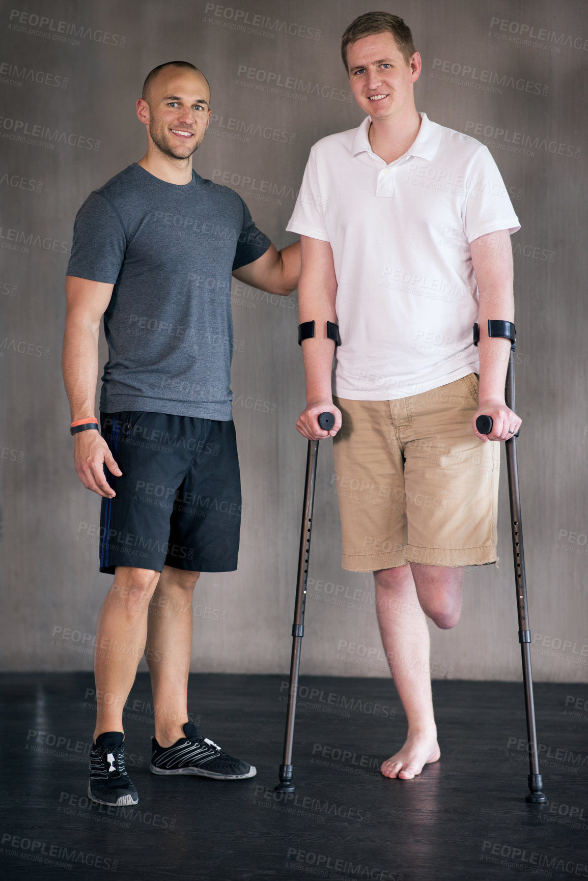 Buy stock photo Physiotherapy, crutches and man with disability in portrait  for walking, muscle strength and coach for support. Amputee, exercise and physiotherapist for physical therapy in healthcare centre 