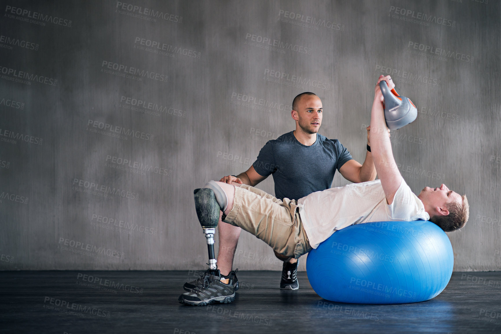 Buy stock photo Trainer, person with a disability and prosthetic leg and dumbbell in physiotherapy, studio and gym ball. Male people, physiotherapy and amputee for wellness, fitness and exercise in rehab center
