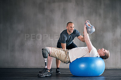 Buy stock photo Trainer, man with a disability and prosthetic leg and dumbbell in physiotherapy, studio and gym ball. Male people, physiotherapy and amputee for wellness, fitness and exercise in rehab center
