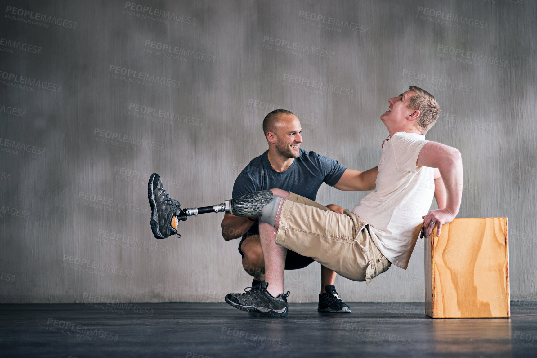 Buy stock photo Physiotherapist, person with a disability and prosthetic leg and trainer in physiotherapy, studio and gym block. Male people, training and amputee for wellness, fitness and exercise in sports center
