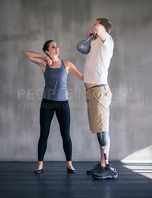 Buy stock photo Shot of a female physiotherapist having a session with a young male amputee