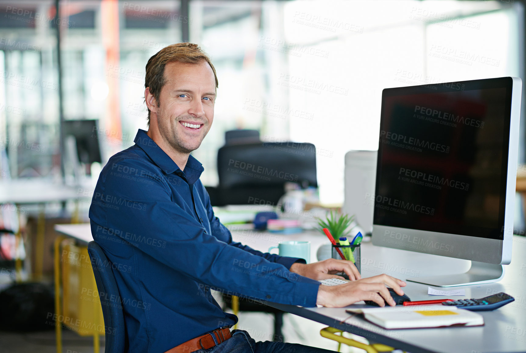 Buy stock photo Man, desk and computer in portrait in office with smile with designer for creative project. Male worker, screen or workstation with technology for web design with graphic for website with confidence 