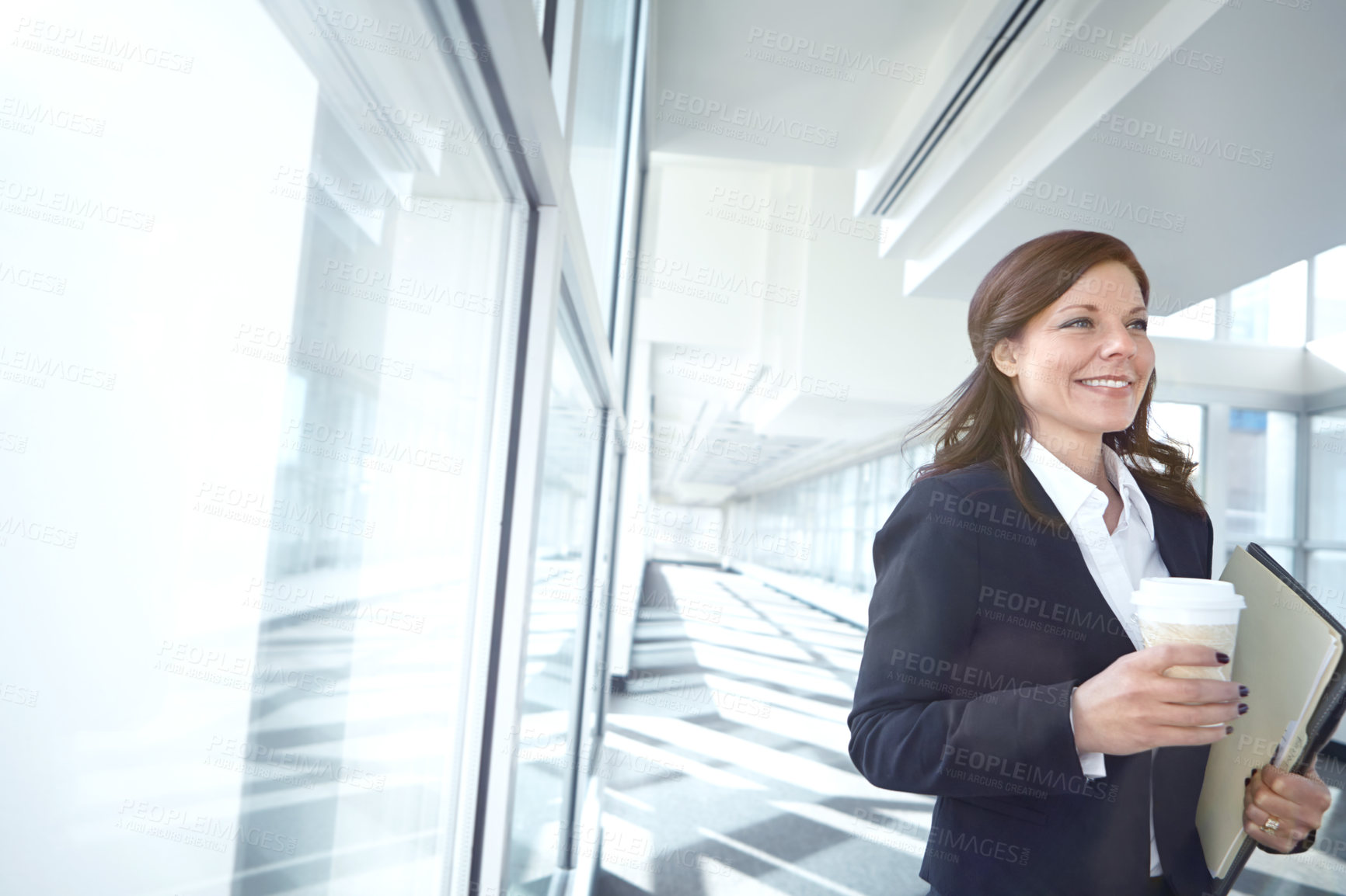 Buy stock photo Walking, coffee or businesswoman in office with smile, beverage or folder at legal consultancy. Drinking tea, happy or confident lawyer with files, documents or paperwork by window in law firm lobby