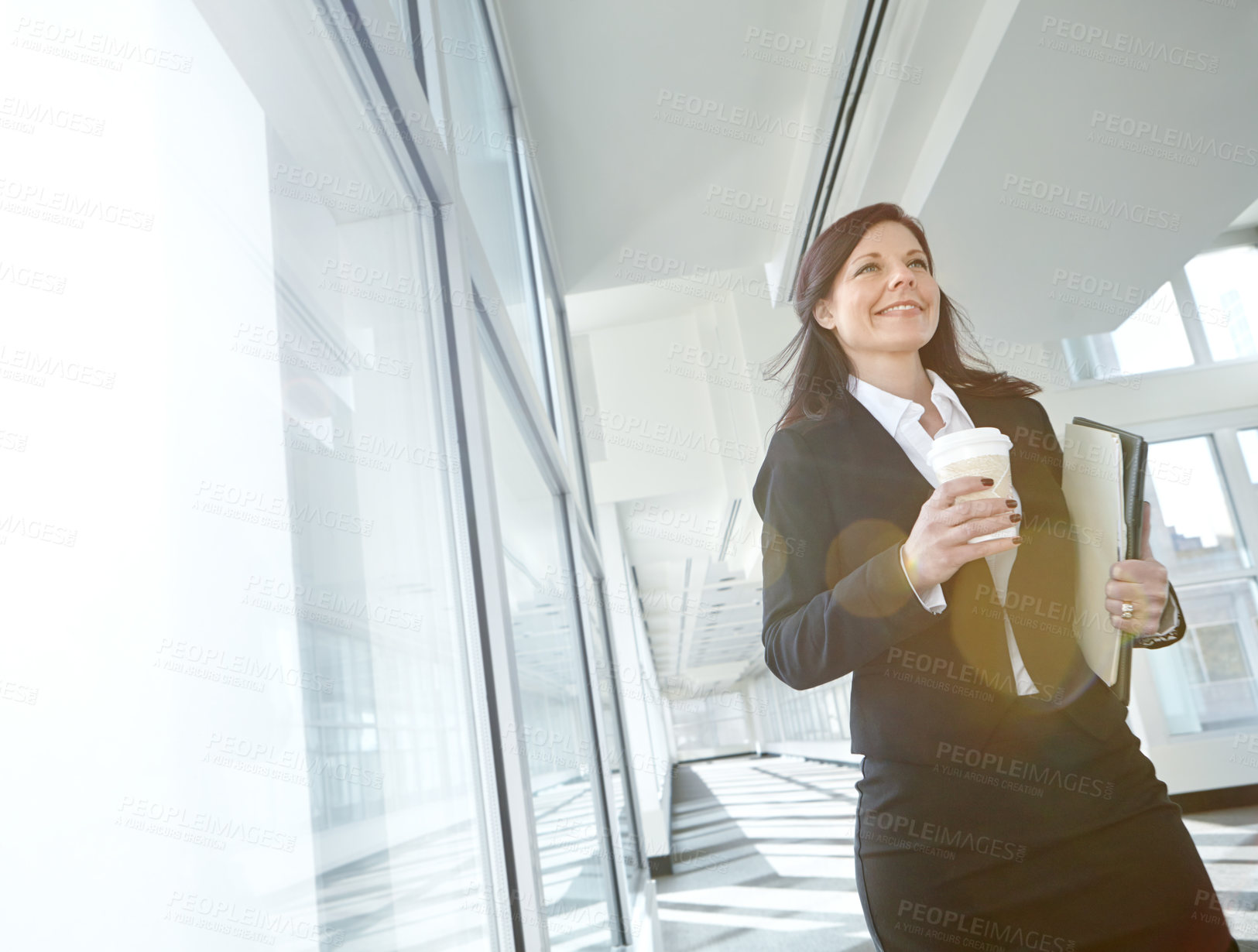 Buy stock photo Walking, drink or businesswoman in office with smile, coffee beverage or folder at legal consultancy. Tea, happy or confident lawyer with files, documents or paperwork by window in law firm lobby