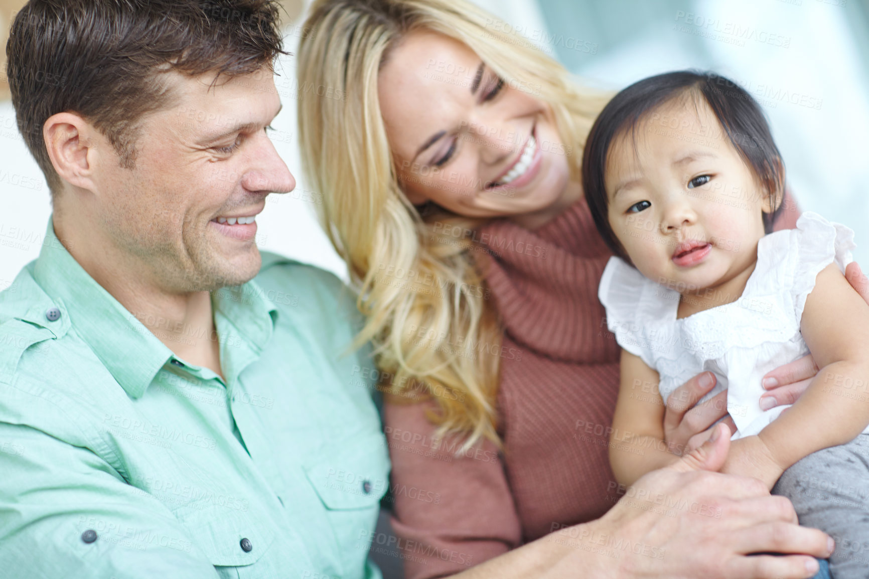 Buy stock photo Happy family, parents and portrait of adopted baby child in home for custody, support and bonding together. Mother, father and face of cute foster kid for connection, diversity and interracial care