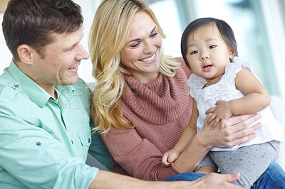 Buy stock photo Happy family, parents and portrait of foster baby child in home for care, support and bonding together. Mother, father and face of cute adopted kid for connection, diversity and interracial love