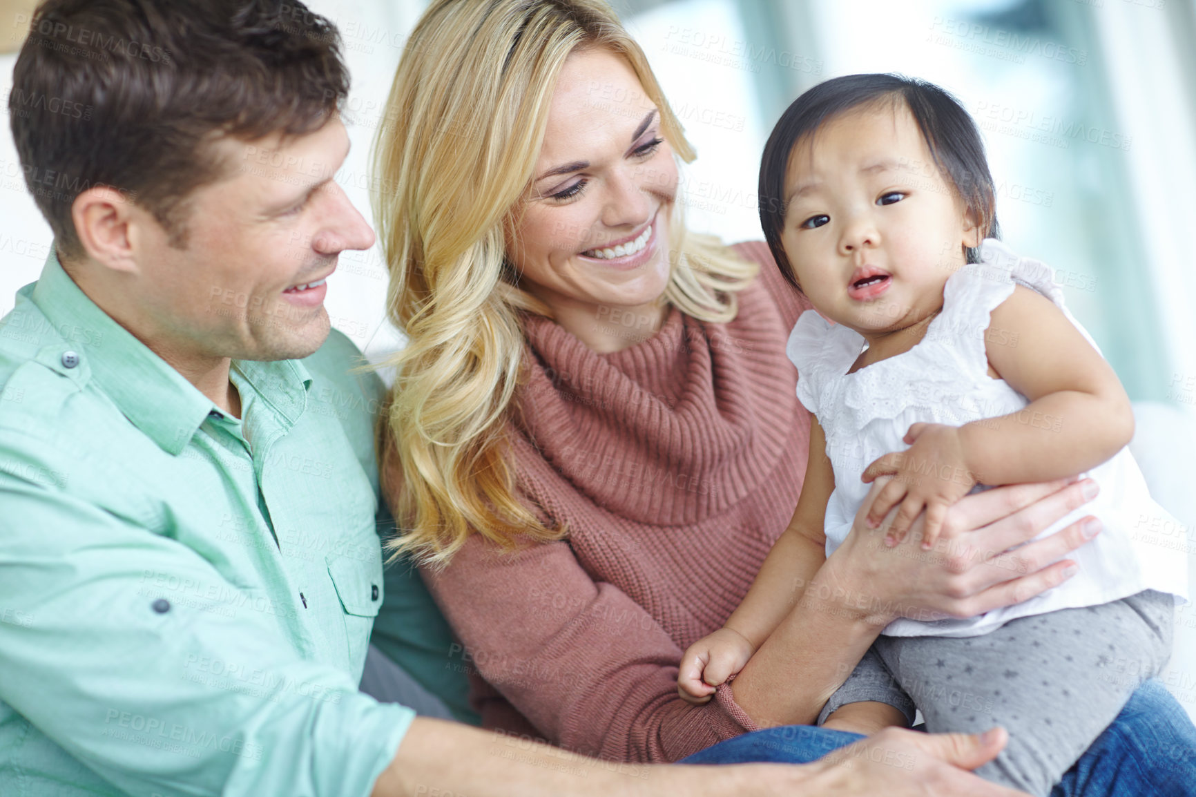 Buy stock photo Happy family, parents and portrait of foster baby child in home for care, support and bonding together. Mother, father and face of cute adopted kid for connection, diversity and interracial love