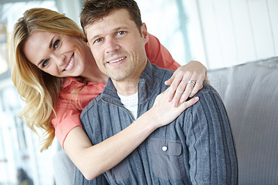Buy stock photo Portrait of an affectionate and happy mature couple spending time together while relaxing at home