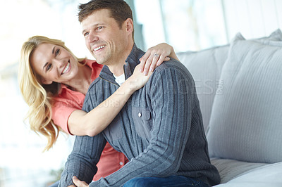 Buy stock photo Cropped shot of an affectionate and happy mature couple spending time together while relaxing at home