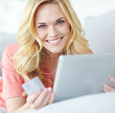 Buy stock photo Portrait of a beautiful young woman using her digital tablet and credit card to shop online