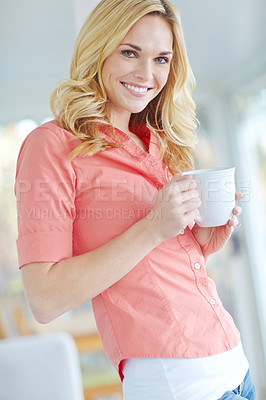 Buy stock photo Portrait of a beautiful young woman drinking coffee while relaxing at home