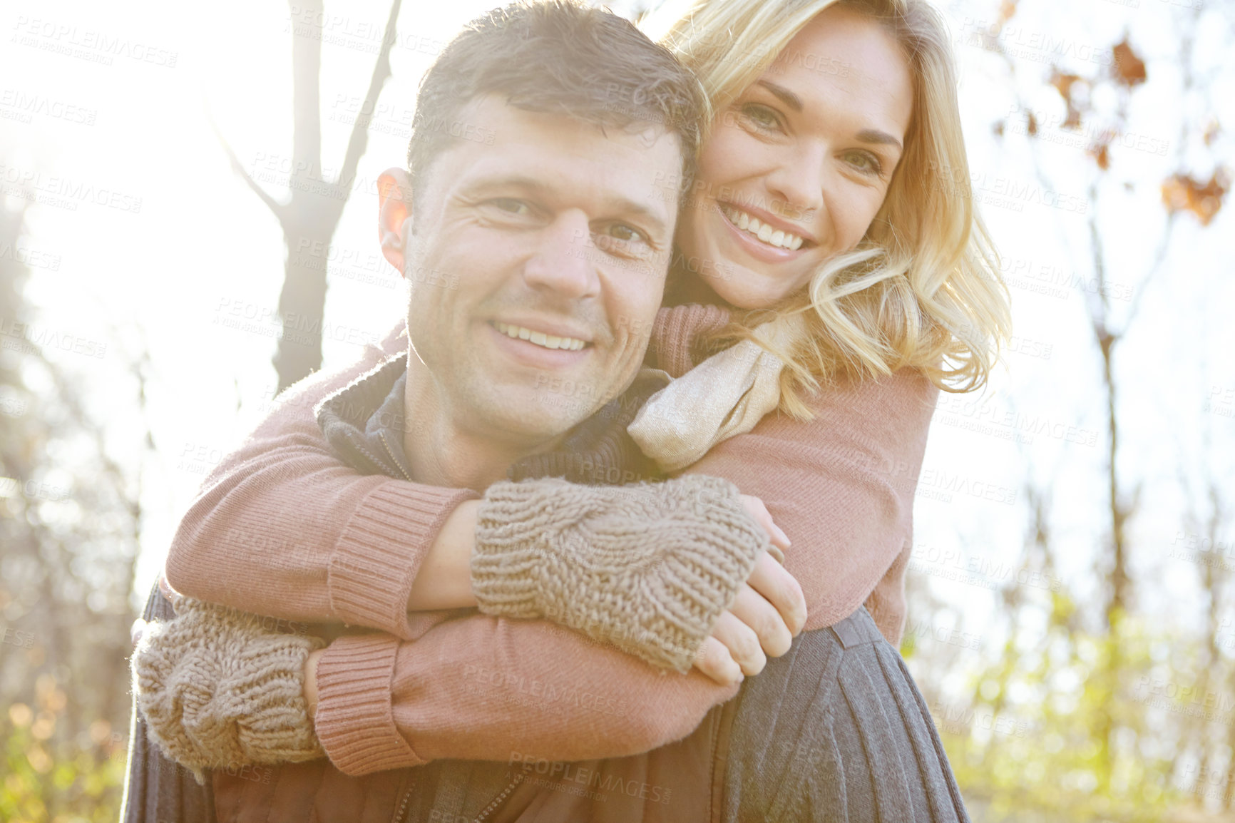 Buy stock photo Couple, love and portrait with piggyback in forest for outdoor break, weekend and care in morning. Happy, man and woman with affection in nature for anniversary, adventure and tourism in Sweden