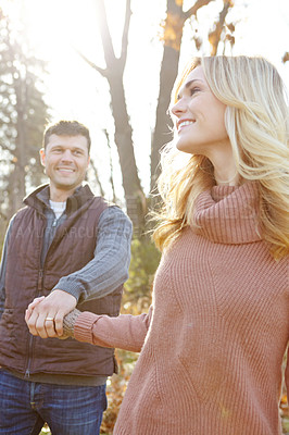 Buy stock photo Thinking, couple and holding hands in nature for walking and adventure in woods or forest. Man, woman and smile or idea for outdoor date, together and support in morning for anniversary in park