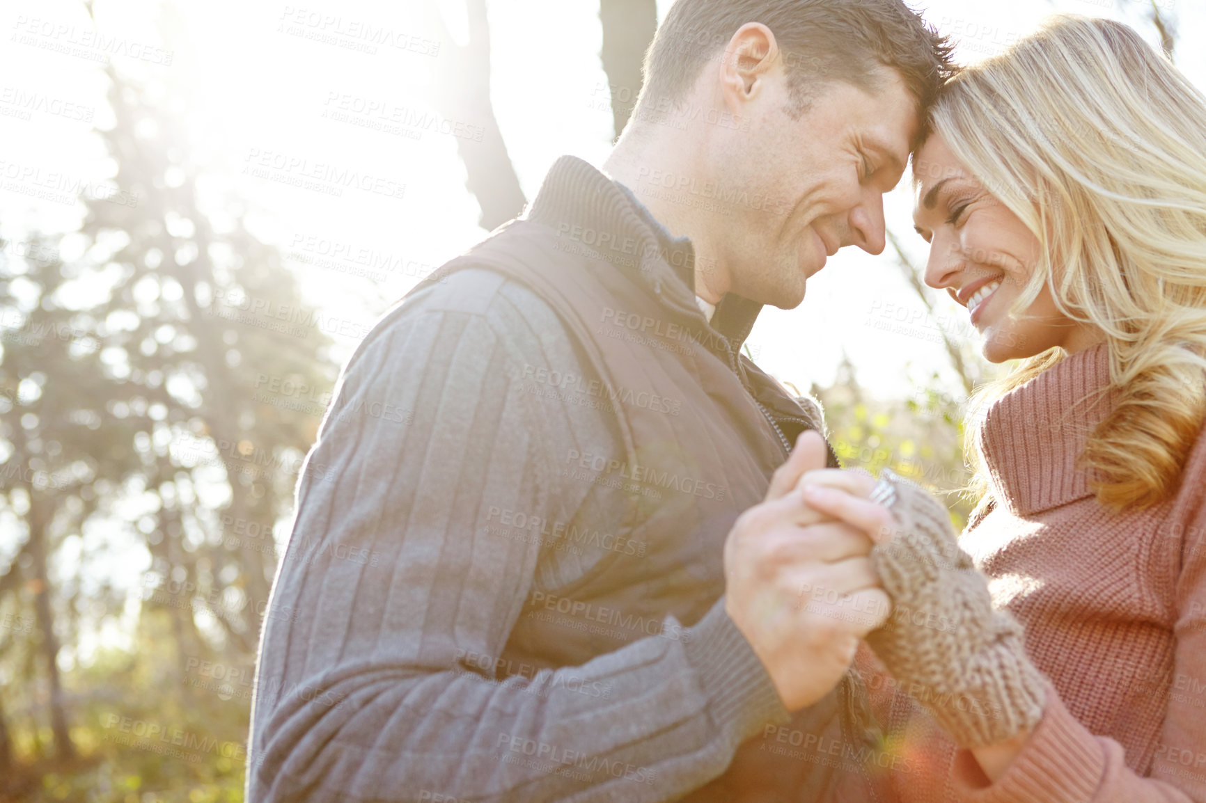 Buy stock photo Holding hands, romance and happy couple in park with love on vacation, valentines day and holiday. Forest, forehead and man with woman, peace and embrace for support or bonding together in nature