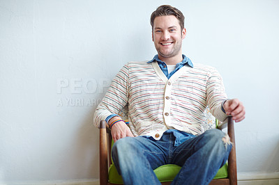 Buy stock photo Portrait, relax and man with smile, armchair and happiness with break, ergonomics and furniture. Face, person and cheerful guy with interior design, casual outfit and comfortable with joy and calm