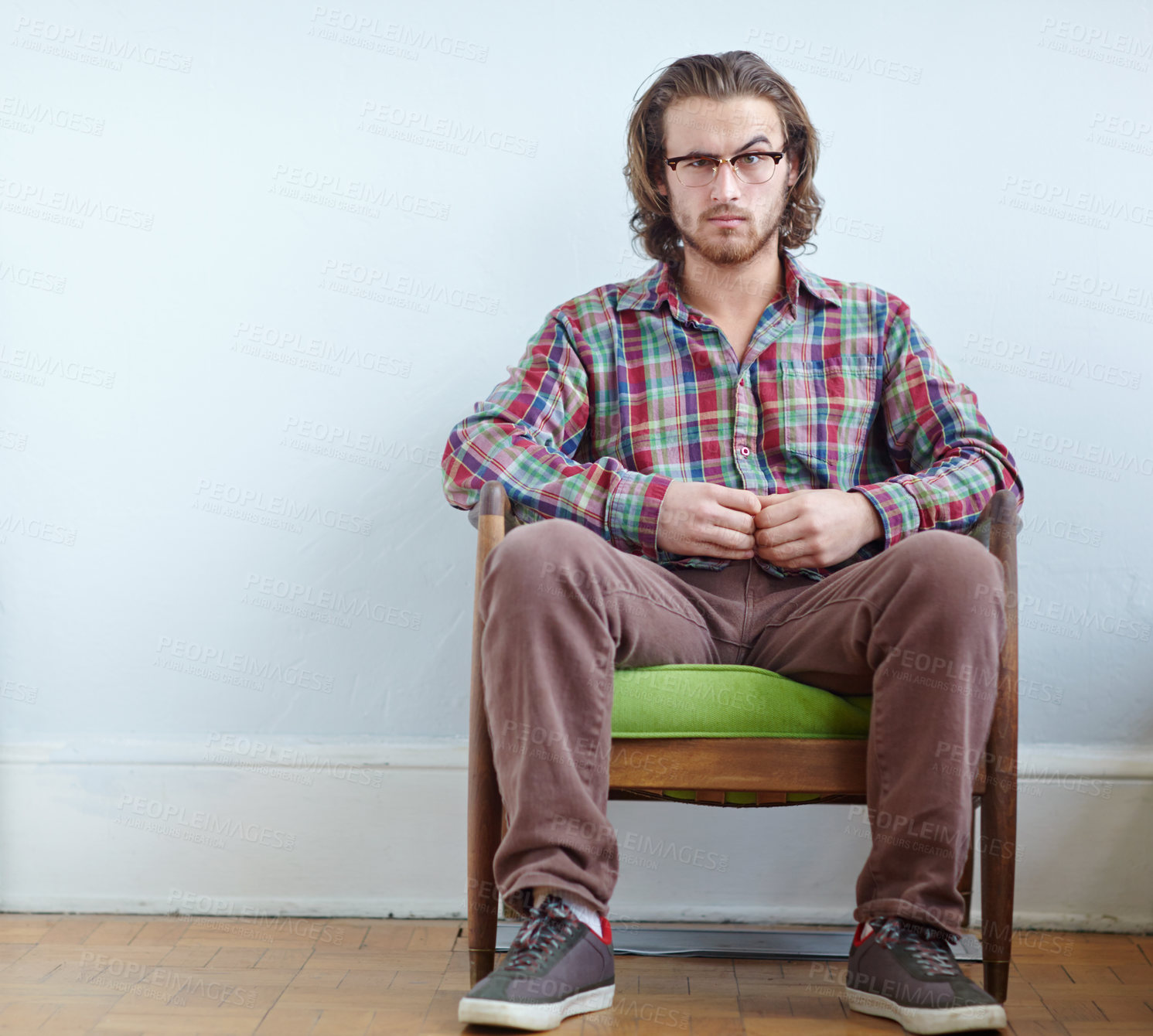 Buy stock photo Man, glasses portrait and vintage clothes with confidence for quirky shirt, style and chair by mockup. Model, retro fashion and sitting by white wall with space, eyewear and plaid fabric in Canada