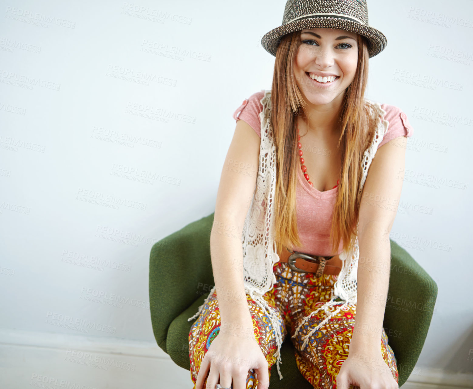 Buy stock photo Portrait of an attractive young woman in a hip outfit sitting on an armchair indoors