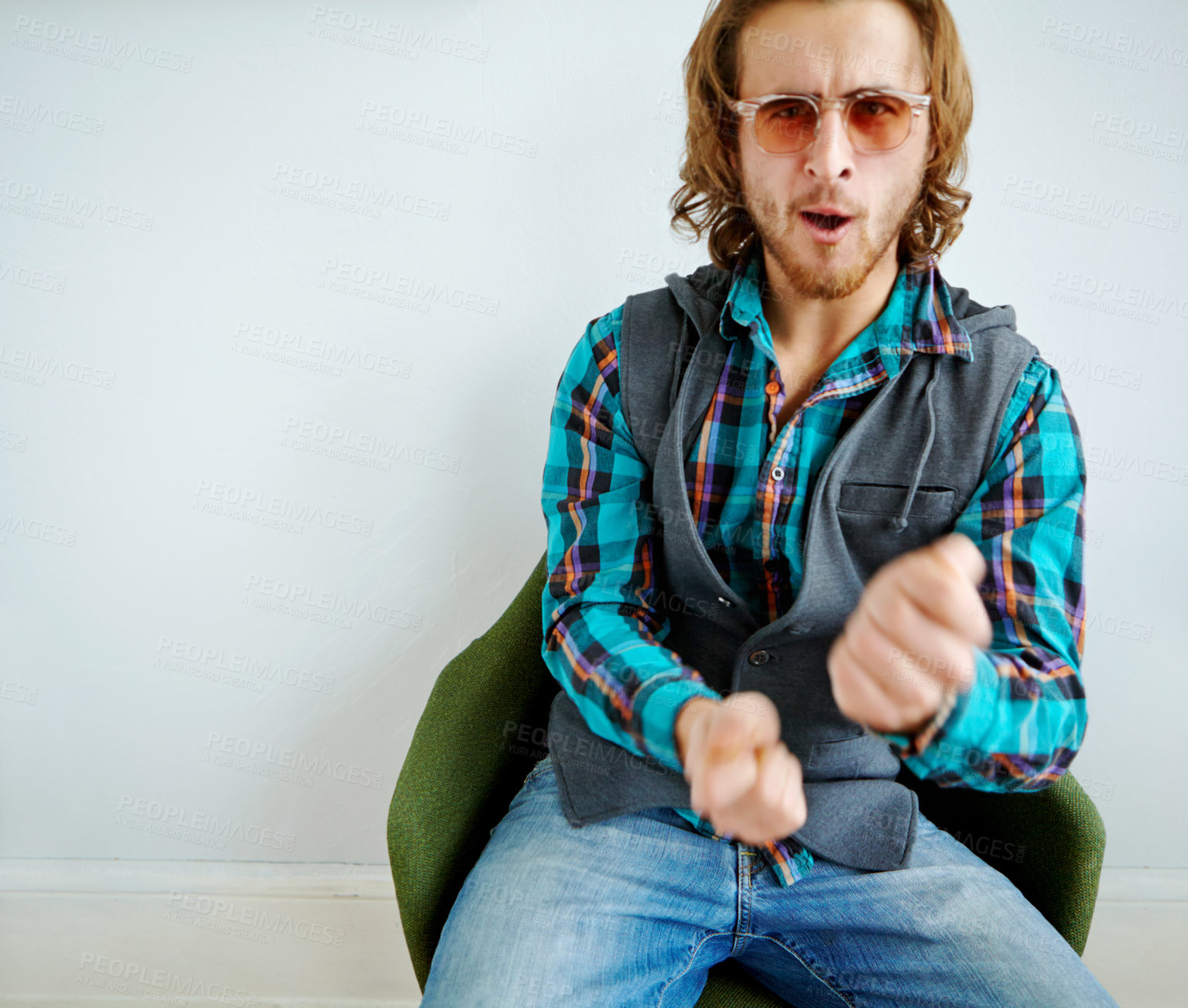 Buy stock photo Fashion, dance and portrait of man in chair with vibrant, trippy and funky outfit for confidence. Happy, colorful and male designer from Portugal with vintage style by white wall in home or house