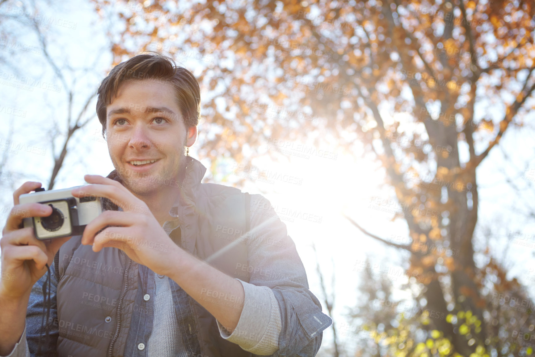 Buy stock photo Happy, man and camera for photography outdoor with adventure travel, explore nature and sightseeing memory. Smile, male photographer with vintage tech for backpacking journey with location picture