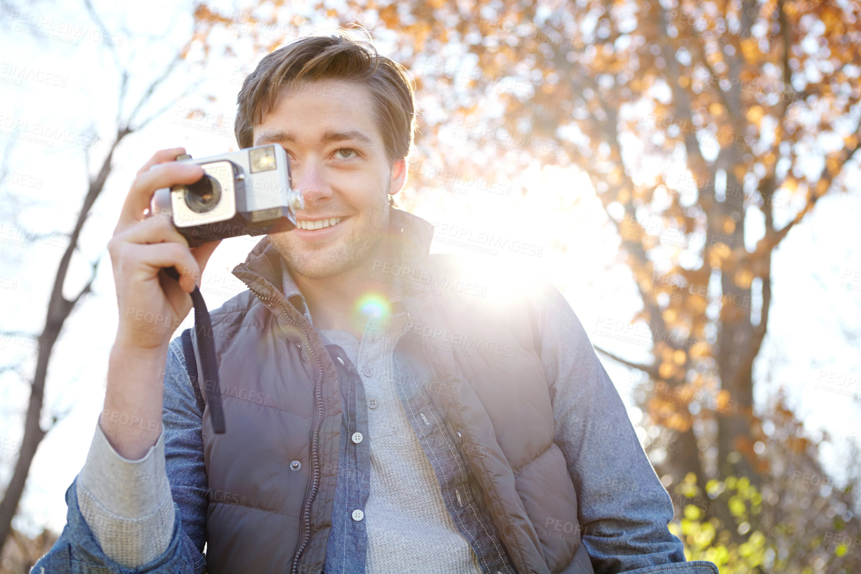 Buy stock photo Man, camera and portrait for photography outdoor with adventure travel, explore nature and sightseeing memory. Smile, male photographer and relax with vintage equipment for scenery of destination