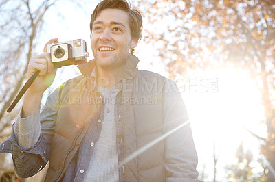 Buy stock photo Man, smile and camera for photography outdoor with adventure travel, explore nature and sightseeing memory. Happy, male photographer and relax with vintage equipment for scenery of destination