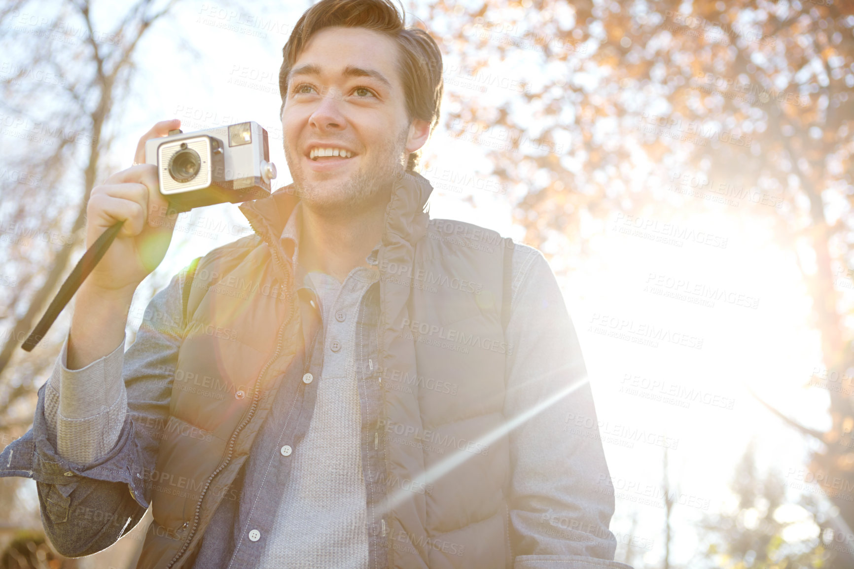 Buy stock photo Man, smile and camera for photography outdoor with adventure travel, explore nature and sightseeing memory. Happy, male photographer and relax with vintage equipment for scenery of destination