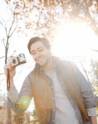 Buy stock photo Photography, smile and man with camera outdoor with adventure travel, explore nature and sightseeing memory. Happy, male photographer and relax with vintage equipment for scenery of destination