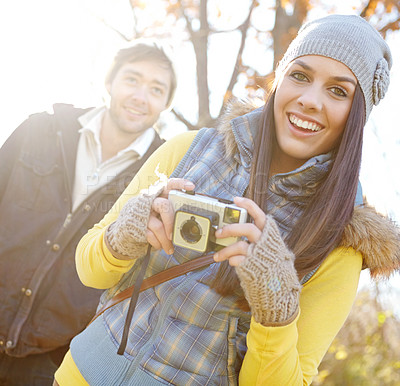 Buy stock photo Couple, smile and camera for photography outdoor with adventure travel, explore nature and sightseeing memory. Happy, woman and man with vintage tech of bonding, picture together or location scenery 